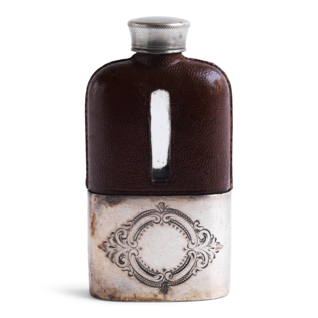 A late Victorian silver plated, shouldered glass and brown leather hip flask with a screw-cap top made by and stamped to the base "James Dickson & Sons, Sheffield".