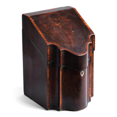 A George III mahogany veneered knife box with an elegant star inlay on the slope of its lid. The serpentine front is banded in satinwood, and it has a compass star decoration with rope cross-banded inlay applied to the underside of its lid - with a silver shield-shaped escutcheon to the lock on the front.