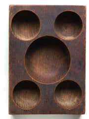 A very handsome Edwardian coin organiser that would have once stood on a grocery store counter - as a handy dispenser for small change. Carved from a single block of oak, with three hollowed-out half-spheres, it has been polished smooth from its years of use, and has developed a wonderful hand-worn patina. Its shop work days may be over, yet it still makes a great organiser - for change, keys, or for all those bits and pieces that accumulate in the kitchen or on the desk.