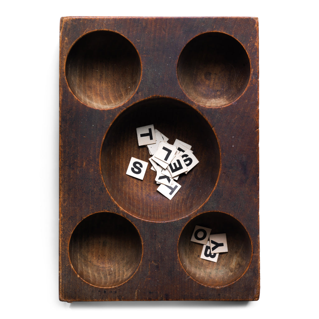 A very handsome Edwardian coin organiser that would have once stood on a grocery store counter - as a handy dispenser for small change. Carved from a single block of oak, with three hollowed-out half-spheres, it has been polished smooth from its years of use, and has developed a wonderful hand-worn patina. Its shop work days may be over, yet it still makes a great organiser - for change, keys, or for all those bits and pieces that accumulate in the kitchen or on the desk.