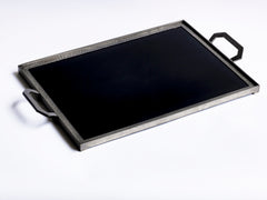 A stunning 1930s Art Deco black Vitrolite glass and hammered pewter tray. The rectangle of black glass is mounted flush in a pewter frame that is held by a pair of art deco shaped pewter handles. 