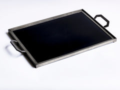 A stunning 1930s Art Deco black Vitrolite glass and hammered pewter tray. The rectangle of black glass is mounted flush in a pewter frame that is held by a pair of art deco shaped pewter handles.