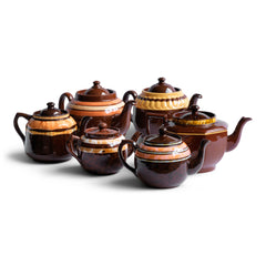 A collection of vintage Brown Bettys with coloured and marbled banding.