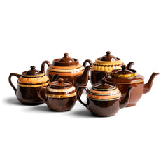 A collection of vintage Brown Bettys with coloured and marbled banding.