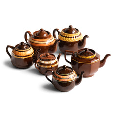 A collection of vintage Brown Bettys with coloured and marbled banding.