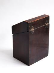 The back of a George III mahogany veneered knife box with an elegant star inlay on the slope of its lid. The serpentine front is banded in satinwood, and it has a compass star decoration with rope cross-banded inlay applied to the underside of its lid - with a silver shield-shaped escutcheon to the lock on the front.