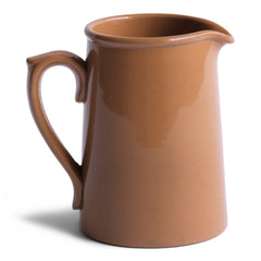 A 920s stoneware cream jug glazed in camel brown and with "Dudson Hanley England Vitrified Stoneware" stamped on its base.