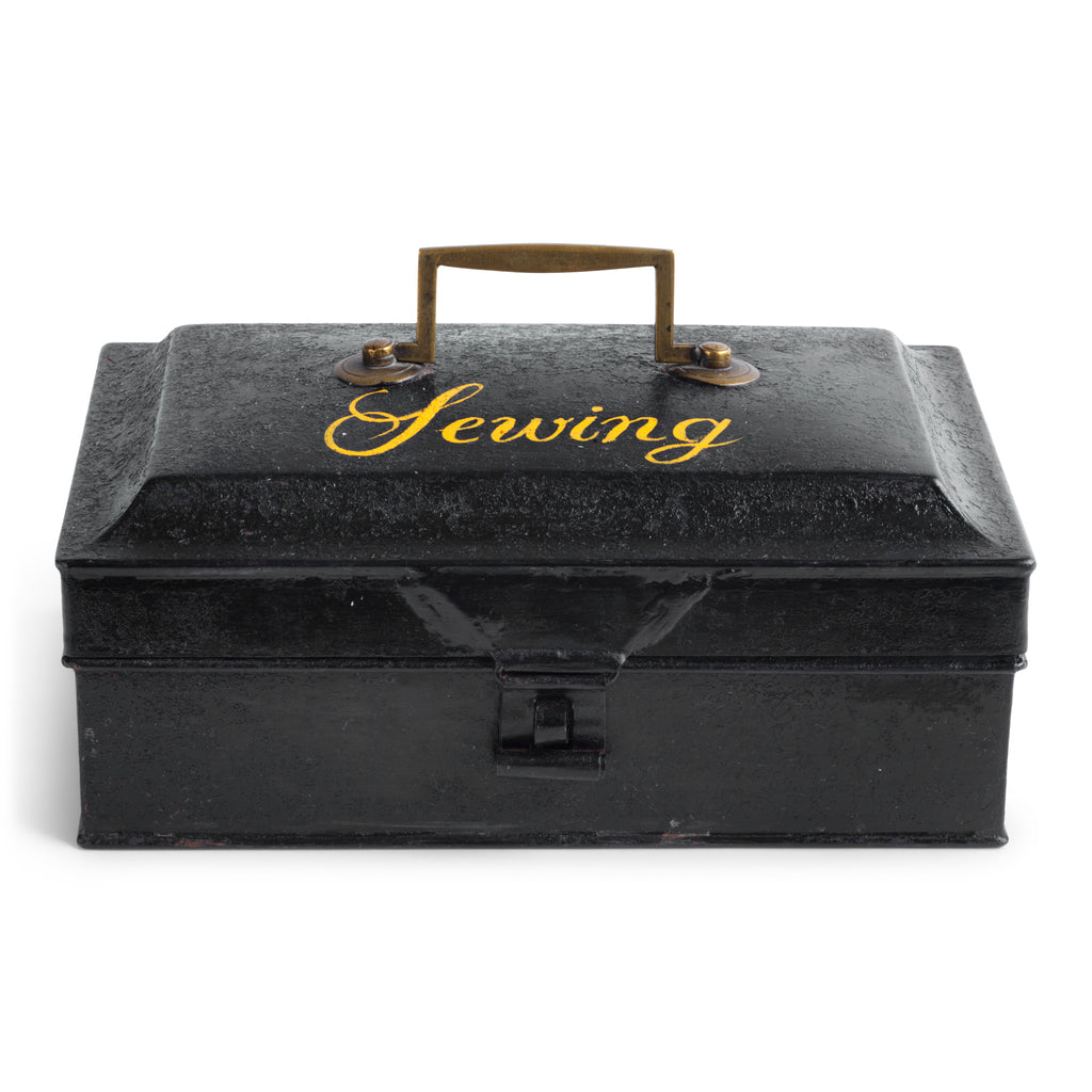 A charming Victorian tin with "Sewing" sign-written in yellow-gold italic font to its lid. Perfect for the storing of all your sewing bits and pieces - from braids and cottons, to scissors, needles and buttons. It has an elegant brass carrying handle, and a hasp, and the lid is beautifully chamfered on all sides.