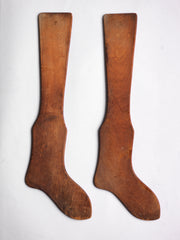 A pair of antique wooden stocking or sock stretchers - very visual, almost Shaker in their appeal, and great for a wall.