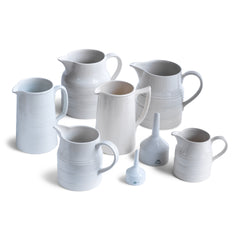 A collection of good late nineteenth century and early twentieth century ironstone and creamware water jugs and funnels