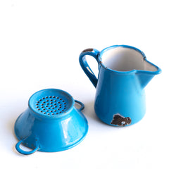 Two very pleasing antique miniature blue enamel kitchen items: a twin-handled sieve and a ewer shaped jug, each with a blue enamel exterior and a white enamel interior. These are part of an extensive collection of miniature pale blue enamel kitchen ware, previously owned by the miniaturist specialist and collector extraordinaire Joan Dunk.