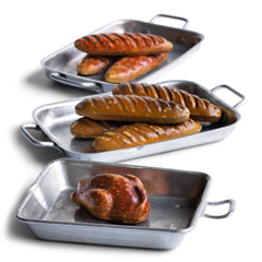 A charming collection of vintage doll's house bloomer style loaves with slashed baked tops; a set of aluminium baking / roasting pans with handles; and a fat little burnished roast chicken - all with their original painted finish, and modelled from a composition plaster material.