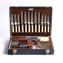 A good-looking silver plated 40 piece canteen of cutlery by Walker & Hall, Sheffield, c.1930, and in its original brown felt lined box.  The box's sections are each labelled: Table Knives; Cheese Knives; Table Forks; Dessert Forks; Dessert Spoons; Sugar Tongs; Tablespoons; Carvers; and Steel. The set is for 6 people.