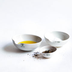 These perfectly formed vintage porcelain pouring dishes are the perfect kitchen-to-table vessels for olive oil, sea salt and crushed black pepper. Once used in a chemist's laboratory, they are now perfectly suited for condiments at the dining table.  