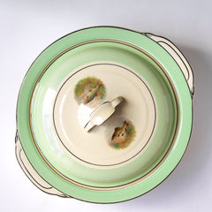 A tureen, part of A glorious 1930s fish dinner service, complete with a large platter for serving a whole fish.  Each piece is embellished with a fresh water fish, such as pike, perch and trout, and contained within a mint-green border. Each item is stamped "Woods Ivory Ware England" to its underside.