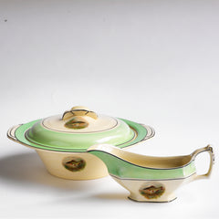 A fish service tureen and sauce boat, part of A glorious 1930s fish dinner service, complete with a large platter for serving a whole fish.  Each piece is embellished with a fresh water fish, such as pike, perch and trout, and contained within a mint-green border. Each item is stamped "Woods Ivory Ware England" to its underside.
