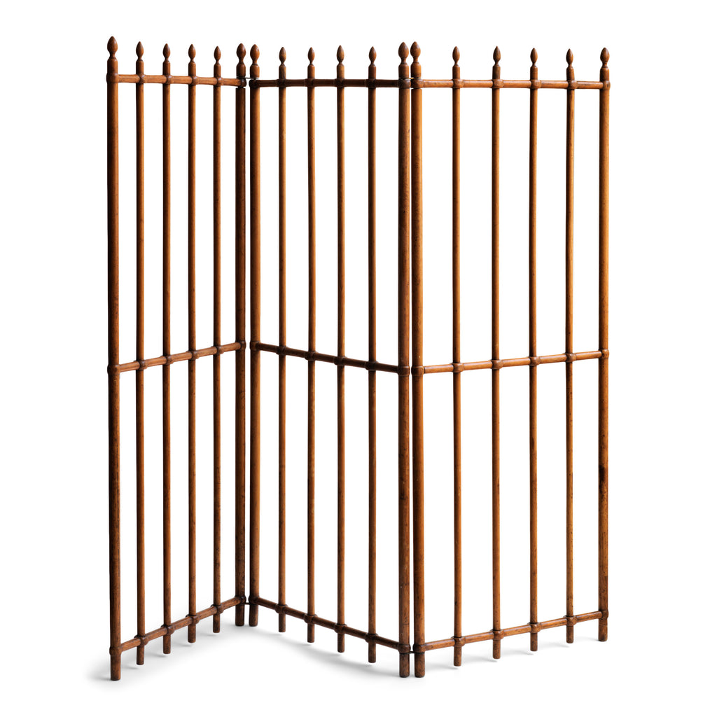 A particularly fine Arts & Crafts gated wooden screen consisting of three open panels.  Each panel is constructed from turned wooden spindles that pass through wooden crossbars - the whole resembling railings. Each spindle is topped with a turned acorn-shaped finial. The execution of the joinery and the pared-back design is pure Arts & Crafts.