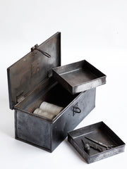 A wonderful 1940s heavy-duty metal work box in stripped steel; fitted with two internal square-shaped steel trays, carrying handle and a hasp for a padlock. Its uses are numerous, and extend from tool storage to artists paints and brushes, to the housing of household items such as scissors, measures and string.