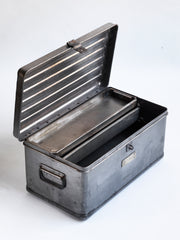 A very handsome 1940s military heavy-duty metal work box in stripped steel. The box is fitted with two internal rectangular steel trays; twin carrying handles and a hasp for a padlock.