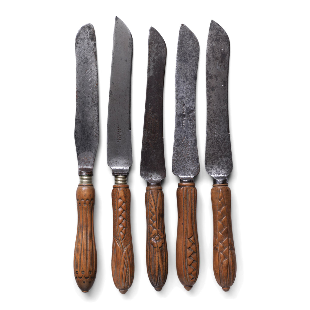 A collection of handsome Victorian bread knives with carved sycamore and beech handles, and carbon steel blades - some stamped "Bread Knife" "Made in Sheffield'.