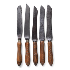 A collection of handsome Victorian bread knives with carved sycamore and beech handles, and carbon steel blades - some stamped "Bread Knife" "Made in Sheffield'.