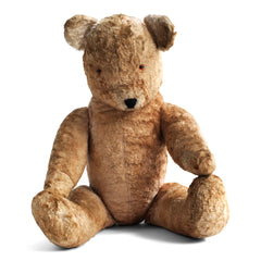 Made from buff-brown mohair plush, our big ted has been much loved yet is still in wonderful condition. Born in the 1950s, his paw pads are also in brown plush and he has amber coloured eyes.  His nose and mouth are embroidered and he has a rotating head, with swivel jointing to his stout arms and legs, and is stuffed with his original wood-wool. He's a handsome boy.