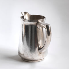 A good, heavy-duty German WMF silver plated milk jug stamped "Wurtt Metall W Fabrik", an abreviation for Württembergische Metallwarenfabrik ( Württemberg metal factory), and "Geislingen Steig", the southern German town where the factory was based.  It also bears an arrow mark, indicating it was for military use - and was most probably made for an English officer's mess.