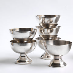 A matching series of silver-plated officer's mess ice cream sundae coupes by James Dixon & Sons of Sheffield.  Each stamped with JD & Sons letters and trumpet logo, along with a military arrow. They are of a lovely shape and weight, and we are selling them individually.