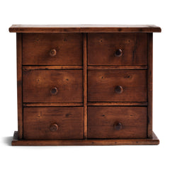 A charming mini bank of drawers in cherry wood with a pine back, comprising of six boxwood drawers, all retaining their original wooden knobs. Handy for a workshop; an office - for staples, clips and bits and bobs; for a hallway - for coins and keys; or for a dressing table - for all your magnificent jewels.