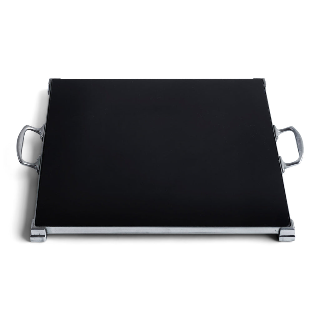 A stunning 1930s Art Deco black Vitrolite glass and chrome tray. The square of black glass is mounted flush in a chrome frame that sits on four stepped corner feet.  Most likely originally used as a cake presentation tray in a grand hotel dining room.