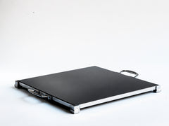 A stunning 1930s Art Deco black Vitrolite glass and chrome tray. The square of black glass is mounted flush in a chrome frame that sits on four stepped corner feet.  Most likely originally used as a cake presentation tray in a grand hotel dining room.