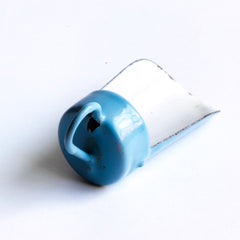 A miniature enamel flour scoop, part of an extensive collection of pale blue enamel miniature antique kitchen ware, previously owned by the miniaturist specialist and collector extraordinaire Joan Dunk; including, flour scoops, sieve, ewer, grater, saucepan, frying pan and a funnel.