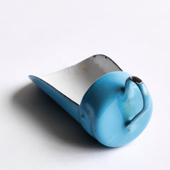 A miniature enamel flour scoop, part of an extensive collection of pale blue enamel miniature antique kitchen ware, previously owned by the miniaturist specialist and collector extraordinaire Joan Dunk; including, flour scoops, sieve, ewer, grater, saucepan, frying pan and a funnel.