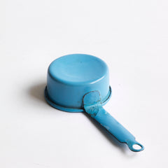 A miniature blue enamel saucepan, part of an extensive collection of pale blue enamel miniature antique kitchen ware, previously owned by the miniaturist specialist and collector extraordinaire Joan Dunk; including, flour scoops, sieve, ewer, grater, saucepan, frying pan and a funnel.