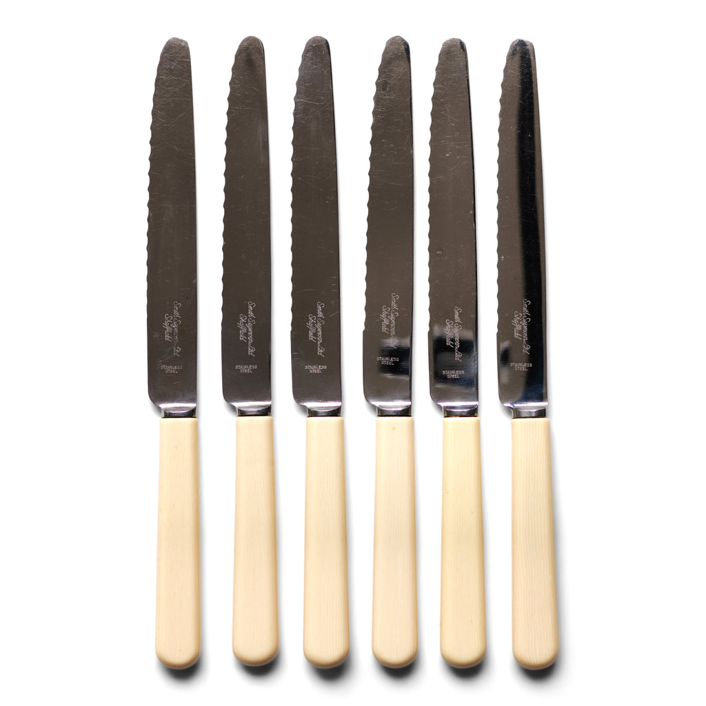 A set of 6 vintage ‘bone-handled’ serrated steak knives each marked Smith Seymour Ltd, Sheffield.