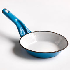 A miniature white speckled blue enamel saucepan with blue lid; a large frying pan; and a long-handled sieve. Part of an extensive antique and vintage collection of miniature pale blue enamel kitchen ware, previously owned by the miniaturist specialist and collector extraordinaire Joan Dunk.