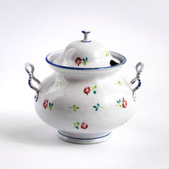 A wonderful, rare antique doll's enamel dinner service decorated with rose buds and leaf sprigs, and each piece finished with a blue trim; very much in tune with the current trend "cottage core", an aesthetic which celebrates an idealised rural life. This is part of an extensive collection of miniature enamel kitchen ware, previously owned by the late miniaturist specialist and collector extraordinaire Joan Dunk.