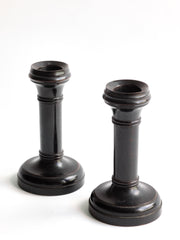 A handsome pair of Edwardian ebony candlesticks, their shape reminiscent of the castles in a game of chess.