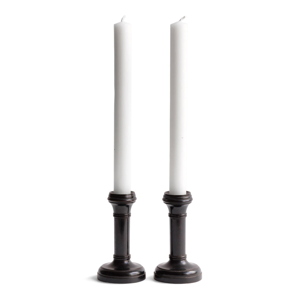 A handsome pair of Edwardian ebony candlesticks, their shape reminiscent of the castles in a game of chess.