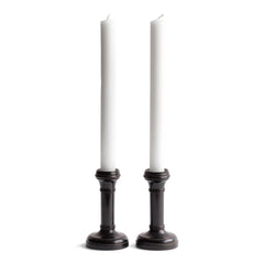 A handsome pair of Edwardian ebony candlesticks, their shape reminiscent of the castles in a game of chess.