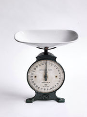 An elegant set of Edwardian weigh scales in cast iron with a detachable white enamelled weighing bowl and with its original dark racing-green painted finish. The dial is marked "Household Scale To Weigh 28lb", and the dial divisions are in imperial lbs and ounces.