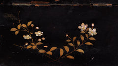 A charming 1920s Japanese lacquered tea caddy inlaid with mother of pearl flowers, leaf sprigs, vine trails, and birds. The bow-topped hinged lid opens up to reveal a further two lacquered boxes with hinged lids which are removable, as shown in the images. Length 23cm Depth 12.5cm Height 14cm.