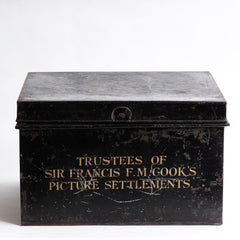 A beautifully proportioned, sign-written document tin with twin handles, hinged lid, original lettering and black paint finish.  It is sign written “Trustees of Sir Francis F M Cook's Picture Settlements”. The trunk-sized picture settlements tin is of special interest, as it is associated with the original owner of Leonardo da Vinci’s Salvator Mundi - the most expensive artwork ever sold.