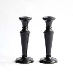 A striking pair of Edwardian ebony candlesticks.