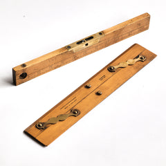 Carpenter's combined spirit level and inch rule: £45 L31cm W3.5cm Thickness 1cm; and a draughtsman's parallel rule with brass hinges and imprinted with "Universal Wood Working Co Ltd Made in England - Warranted Best Box": £58 Length 31cm Width 5.5cm Thickness 0.5cm