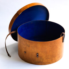 A very impressive Edwardian ply hat box with original luggage stickers, leather strap and cobalt blue interior. The stickers document the owner's grand tours of Italy and Egypt, from the Grand Hotel in Bologna to the Albergo Nazionale of Rome; and then in Egypt - the Hotel Cecil Alexandria, and the Luxor Winter Palace, to the Cataract Hotel of Assouan.