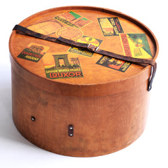 A very impressive Edwardian ply hat box with original luggage stickers and leather strap. The stickers document the owner's grand tours of Italy and Egypt, from the Grand Hotel in Bologna to the Albergo Nazionale of Rome; and then in Egypt - the Hotel Cecil Alexandria, and the Luxor Winter Palace Luxor, to the Cataract Hotel of Assouan. There's also an excursion to Singapore with stay at the Raffles Hotel.