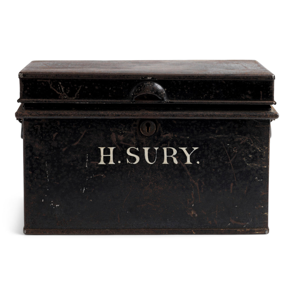 A beautifully proportioned Edwardian document tin with its original lettering "H.Sury" and black paint finish. It has a hinged lid and twin carrying handles.