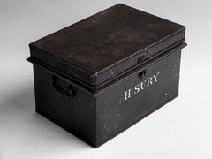 A beautifully proportioned Edwardian document tin with its original lettering "H.Sury" and black paint finish. It has a hinged lid and twin carrying handles.