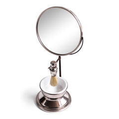 A good-looking Edwardian gentleman's shaving companion, consisting of a pivoting circular mirror set on a stand, a badger hair shaving brush and a white vitrolite glass bowl set in a nickel plated bowl-shaped stand. It was most likely made for travel, as it is light-weight and small, and therefore very transportable.